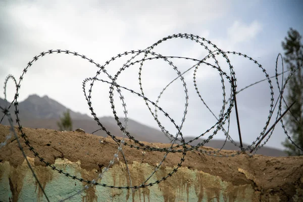 Barbed wire on the wall in Ishkashim, Afghanistan