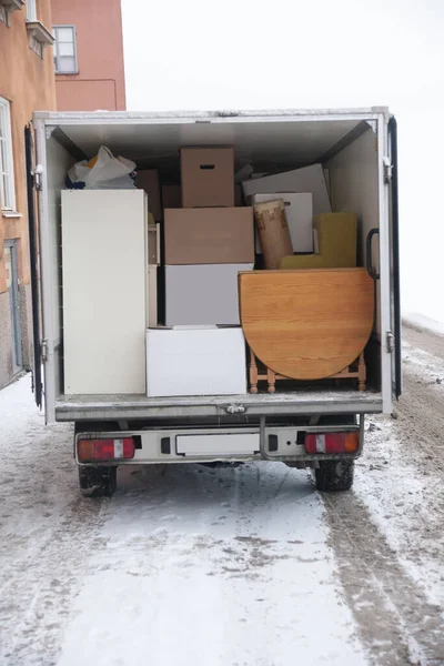 Van with boxes and furniture, someone moving to a new flat