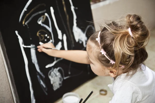 Маленькая девочка рисует картину акрила — стоковое фото