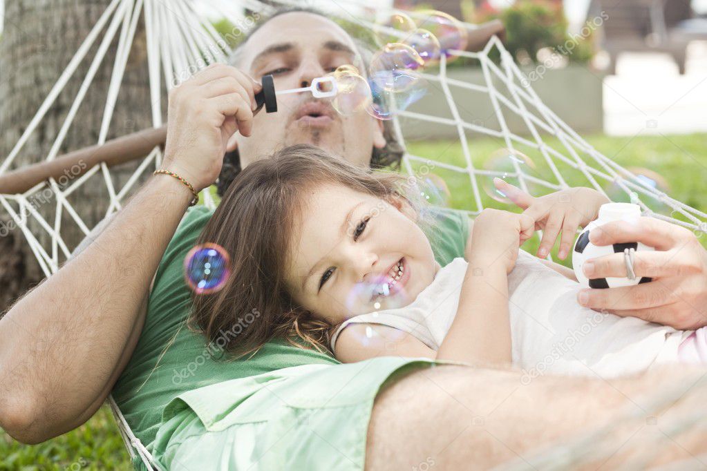 Dad and daughter in a hammock