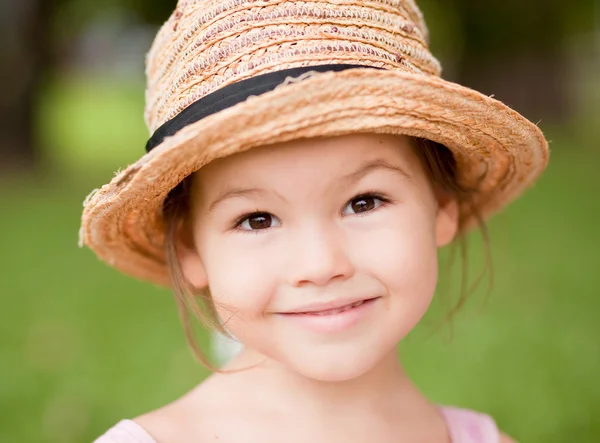 Дівчина в солом'яному капелюсі в парку — стокове фото