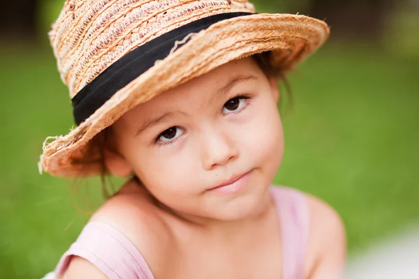 Дівчина в солом'яному капелюсі в парку — стокове фото