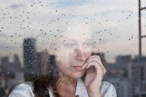 Melancholy reflection of the girl in the window — Stock Photo, Image