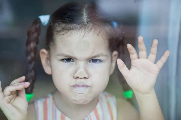 Angry asian girl misses at the window — Stock Photo, Image