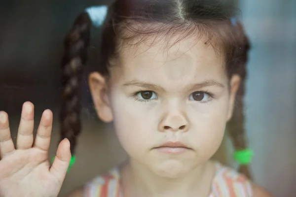 Asian girl misses at the window — Stock Photo, Image