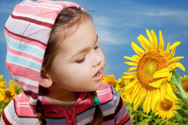Asian girl walks in a field of sunflowers 