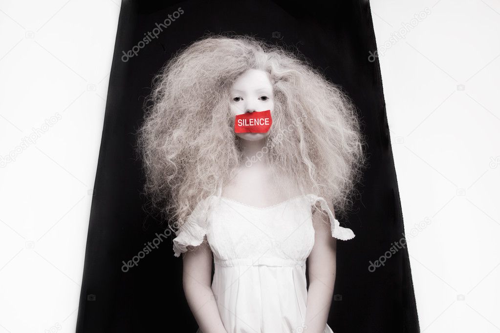 Young woman with red tape on mouth