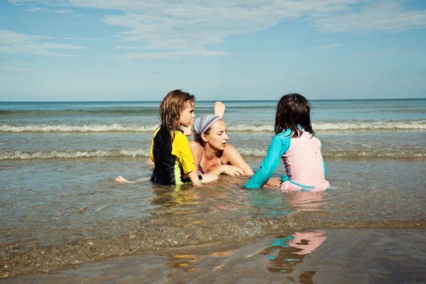 Mother and daughters on the beach — Stock Photo, Image