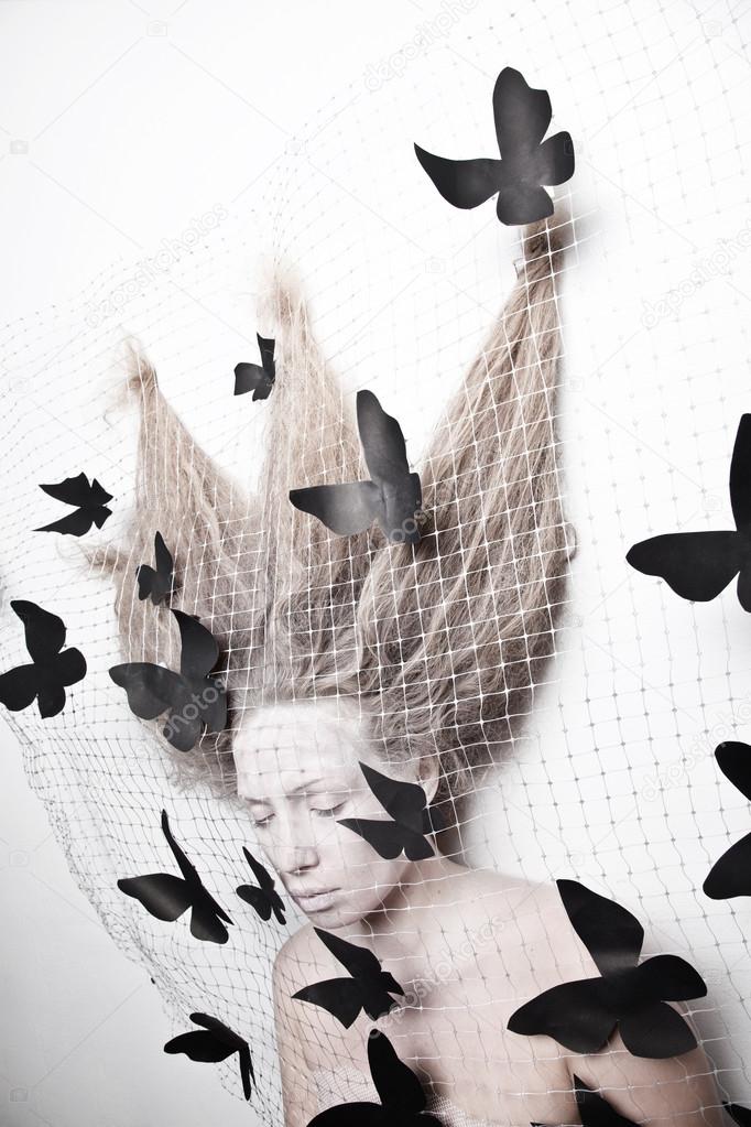 pale woman in cocoon with butterflies