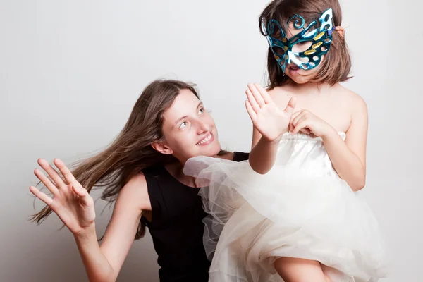 Жінка і дівчина в карнавальній масці танцюють — стокове фото