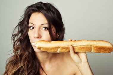 Hungry woman eating baguette clipart