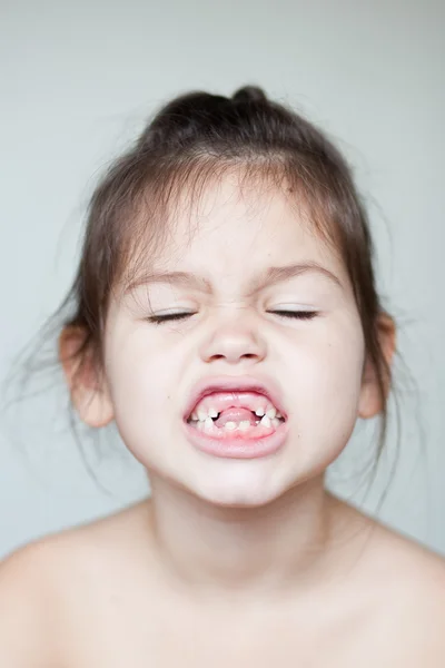 Menina mostrando seus dentes de leite desaparecidos — Fotografia de Stock