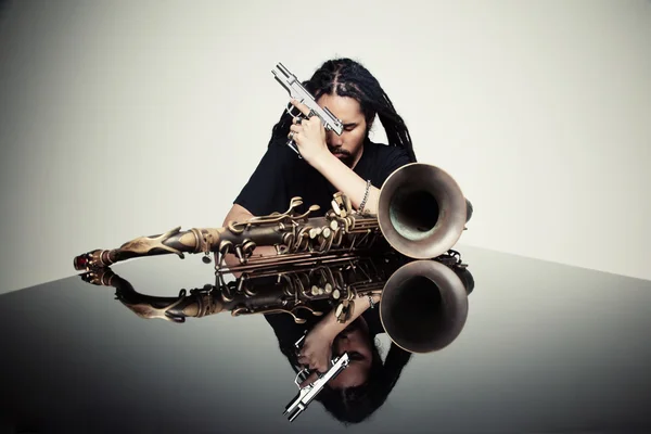 Saxophoniste avec un pistolet à la main — Photo