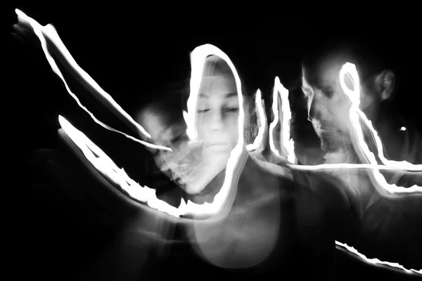 Man and woman painting with light — Stock Photo, Image
