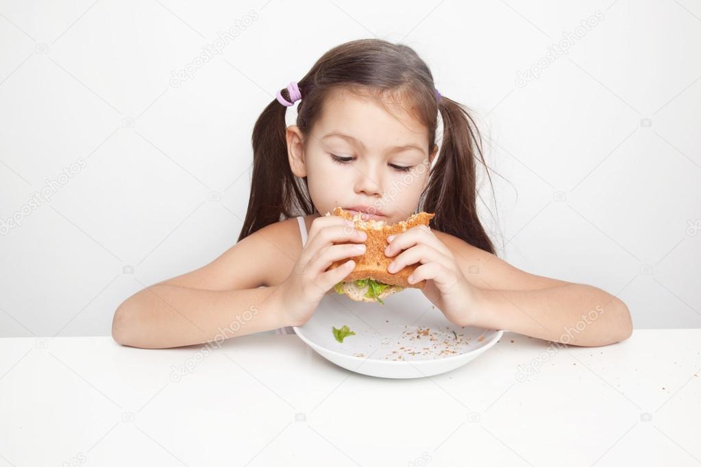 Girl eating a vegan sandwich
