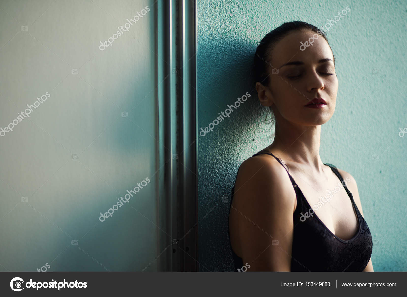 Depressed Woman Leaning Against Wall Stock Photo By RadaRani