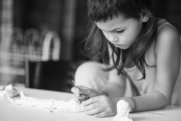 Focused Little Girl Sculpting Pottery Human Statue Sitting Table — Stock Photo, Image