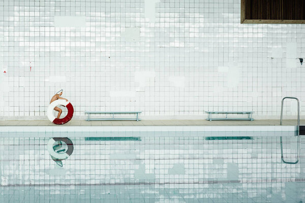 boy with flotation ring in swimming pool