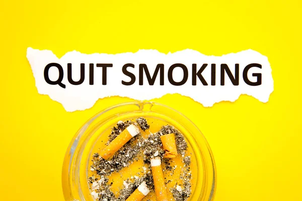 Parar de fumar - Saúde - com cinzeiro e texto impresso sobre fundo amarelo — Fotografia de Stock