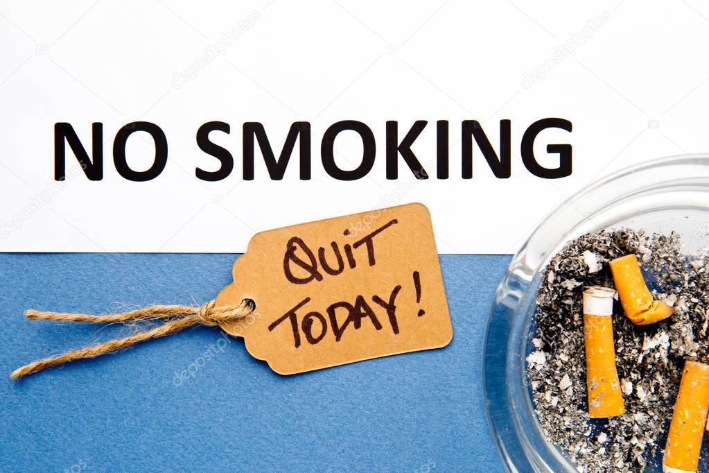 No Smoking  - Quit Today - with ashtray with printed words on blue and white background