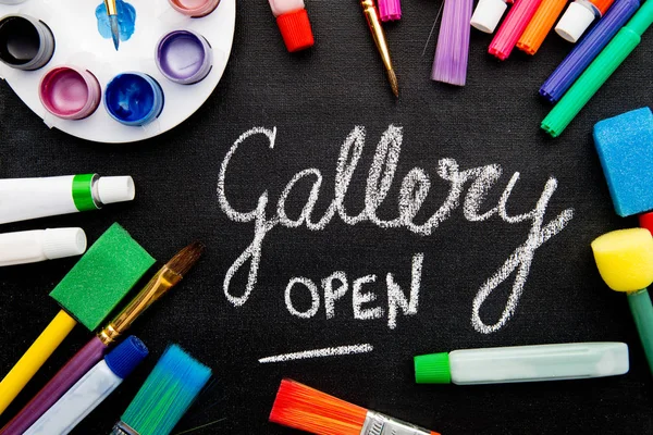 Art - Gallery Open - handwritten on chalkboard surrounded by art equipment — Stock Photo, Image