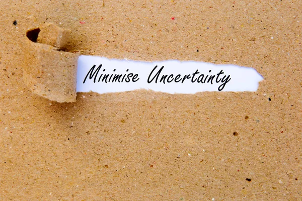 Minimise Uncertainty - printed text underneath torn brown paper