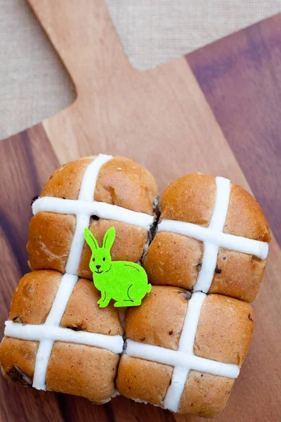 Easter - Hot cross buns and easter bunny on wooden cutting board