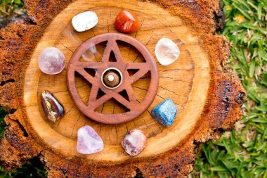 Burning incense cone  in wooden pentacle incense holder on natur clipart