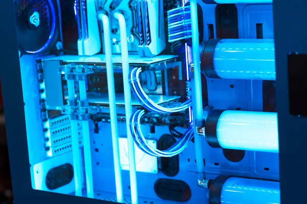Inside a high performance computer. Computer circuit board and CPU cooling fans illuminated by internal LEDs inside a server class computer.