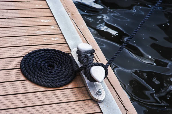 Marina bollard bitt at jetty for boats, ships and yachts mooring knecht cross — Stock Photo, Image