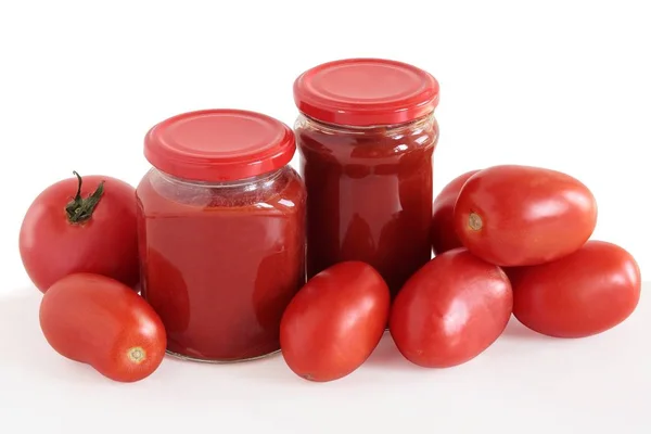 Red tomatoes and tomato pulp as preserve — Stock Photo, Image