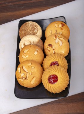 Fırın kurabiyelerini siyah tepsi resmiyle karıştır