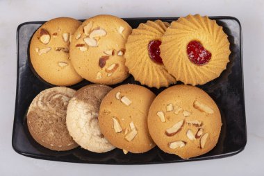 Fırın kurabiyelerini kara parçası pozisyonunda siyah tepsiyle karıştır 