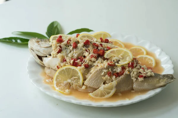 A Seabass steam with lemon, garlic and red chili - Thai food, on white plate — Stock Photo, Image