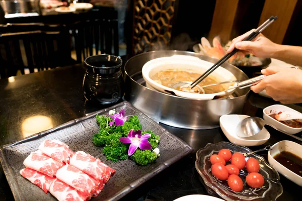 Cooking Chinese shabu with cherry tomato and yummy beef meat — Stock Photo, Image