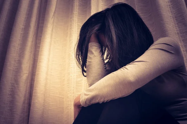 Donne depresse sedute nella stanza buia, da sole, tristezza, concetto emotivo — Foto Stock