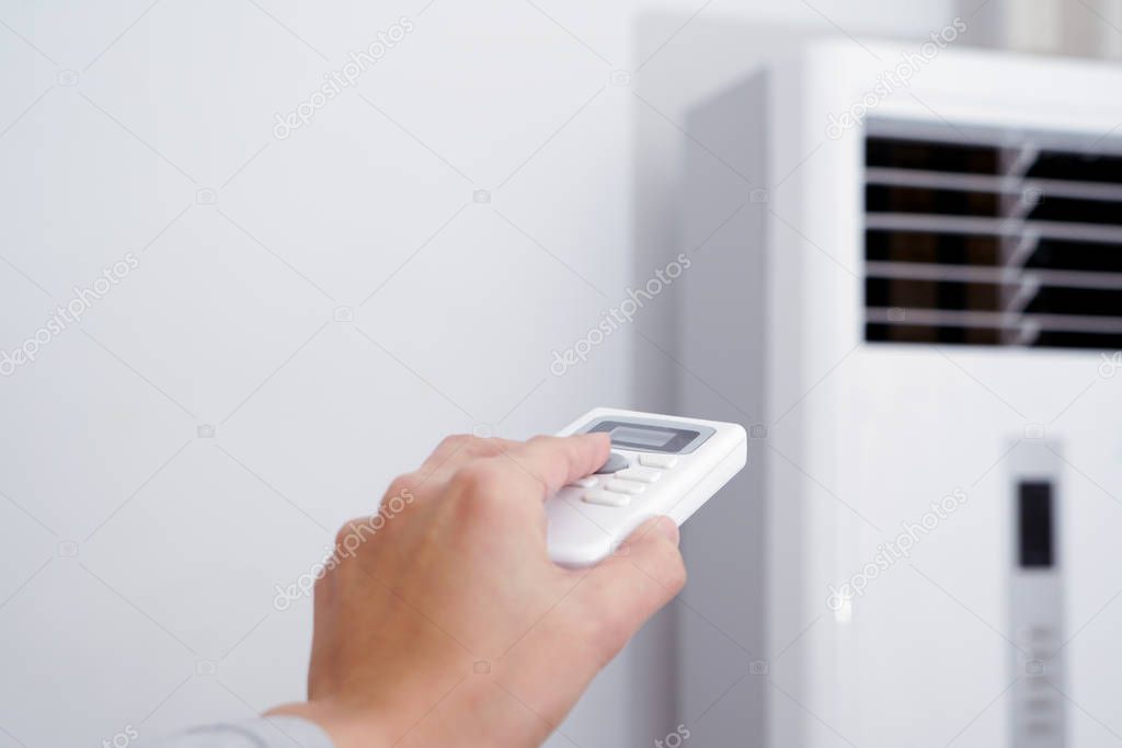 women hand is regulating the heater/air condition temperature