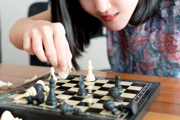 the white chess on women hand is fighting with black, think, discuss, committed, competition, winner, successful, dedicate concept