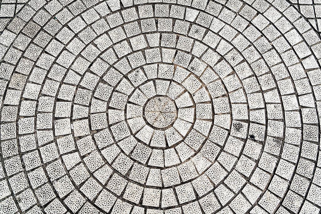 Closeup paving curved circle stone brick on pathway texture, abstract