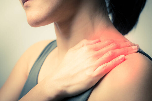 closeup women neck and shoulder pain/injury with red highlights on pain area with white backgrounds, healthcare and medical concept