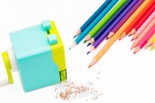 pastelově modrá žlutá rotační tužka ořezávátko hobliny s dřevěné barevné tužky izolovaných na bílém pozadí, zpět do školy vzdělávací koncepce
