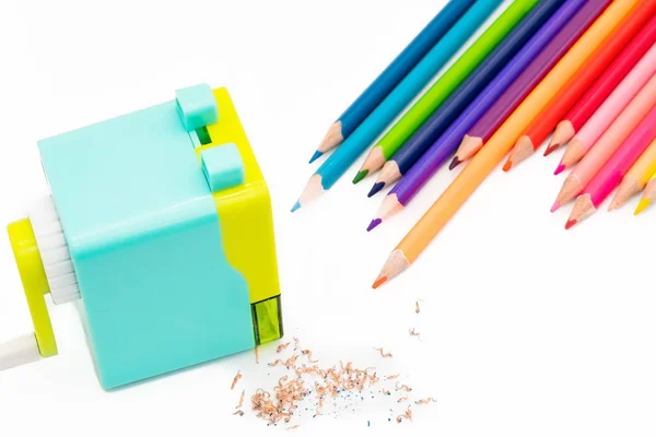 Pastel blue yellow rotary pencil sharpener shavings with wooden colorful pencils isolated on white background, back to school education concept — Stock Photo, Image