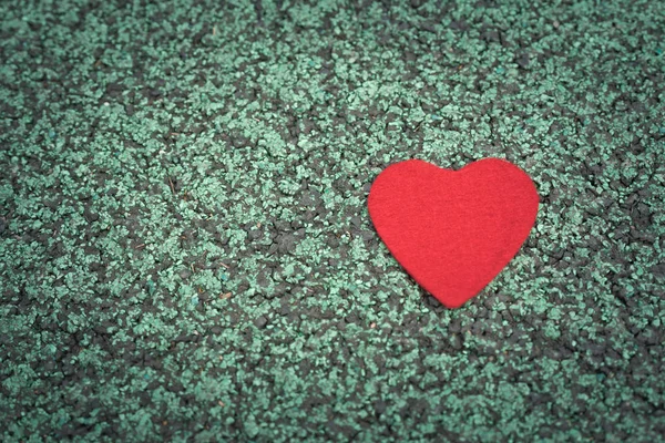 red heart on the green walking path backgrounds with copy space