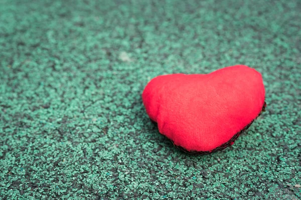 red heart on the green walking path backgrounds with copy space