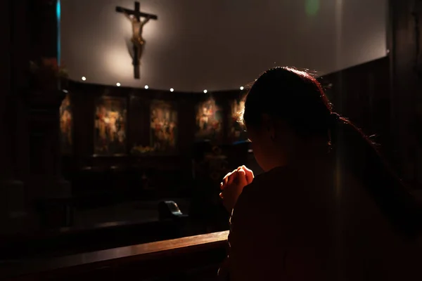 Depressed women sitting in the low light church and praying to Jesus on the cross, International Human Rights day concept — Stock Photo, Image