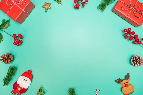 Christmas background concept. Top view of Christmas decoration, Santa Claus and reindeer with red gift box on green background — Stock Photo, Image