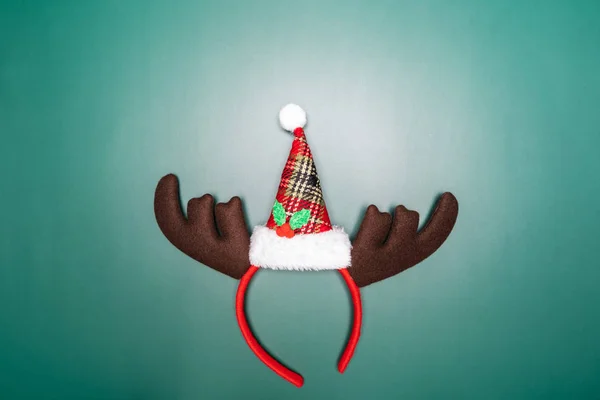 Christmas background concept. Top view of Christmas reindeer headband on green background — Stock Photo, Image