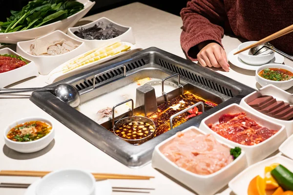 Chinese Hotpot shabu spicy and sour soup with meat and seafood, Suki Chinese style - selective focus — Stock Photo, Image