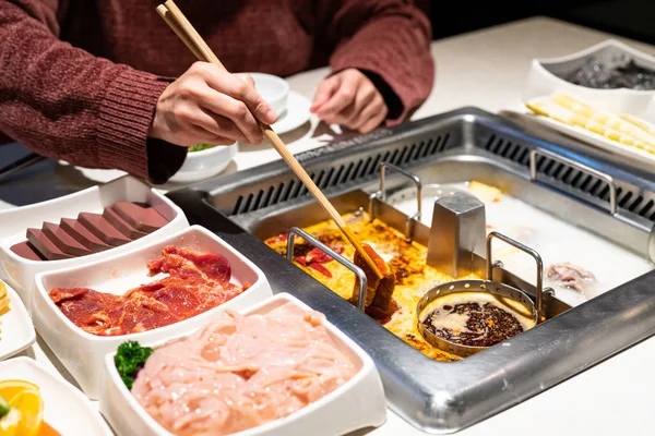 Chinese Hotpot shabu spicy and sour soup with meat and seafood, Suki Chinese style - selective focus — Stock Photo, Image