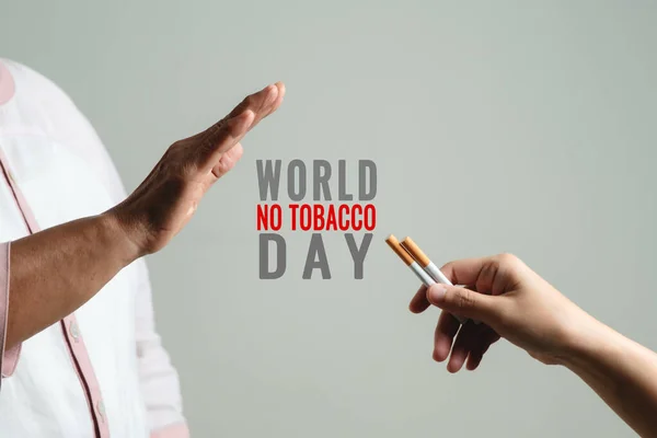 Quit smoking, no tobacco day, mother hands gesture reject proposal the cigarette